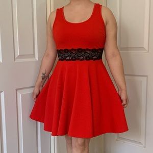 Red, short above the knee dress with black lace strip center.